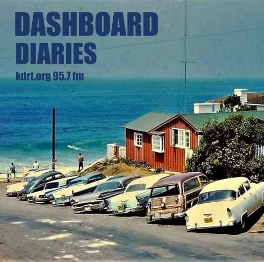 60's photo of cars parked at the beach, with a beach house behind 