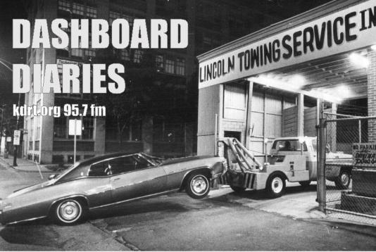 Vintage car being towed by a tow truck