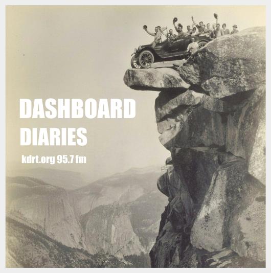 Vintage photo of a 1920's car, full of people waving, on the edge of Glacier Point in Yosemite