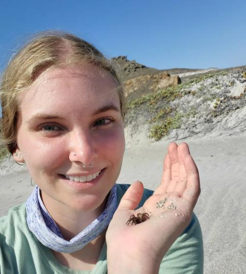 Emma Jochim, holding a spider