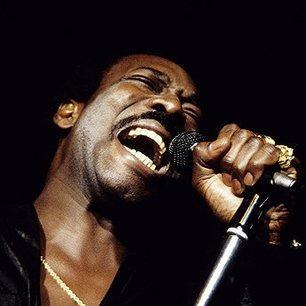 Wilson Pickett singing intensely into a microphone