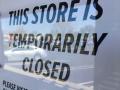 "Temporarily closed" sign in door