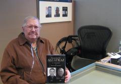 Robert Luke, with his book, at Alcatraz