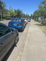 PHOTO: Student cars parked along the sidewalk at Davis High CREDIT: Chase Bruno